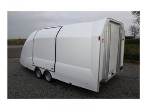 rear quarter shot of a small white enclosed vehicle trailer