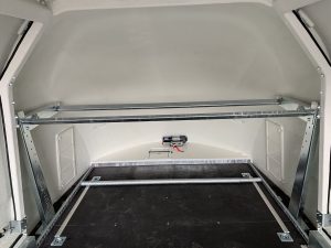 Tyre wheel rack fitted to a white enclosed trailer