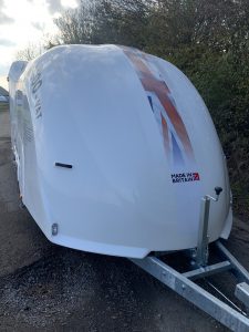 White vehicle trailer with a union jack and text on