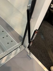 Close up of the gas strut fitted to a vehicle ramp