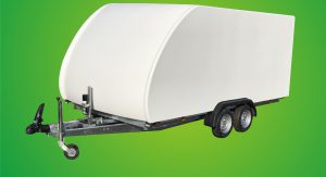 White enclosed vehicle trailer in front of a green background