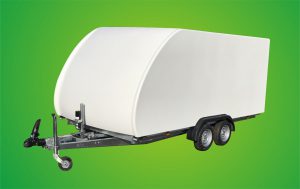 White enclosed vehicle trailer in front of a green background