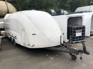 White enclosed vehicle trailer in a stockyard