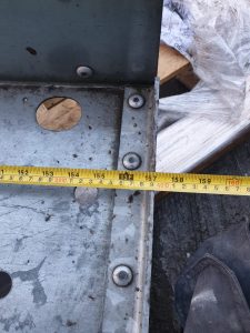Tape measure measuring a metal frame