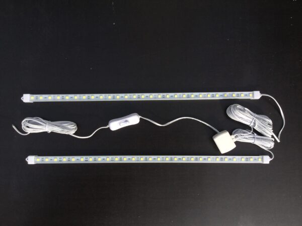 Two LED strips with attached wires and switches