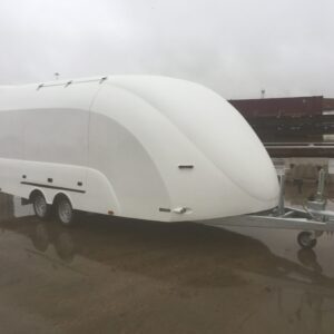 White enclosed vehicle trailer in a wet car park