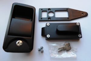 Black door handle and lock with mechanism laid out next to it