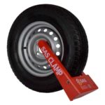 Red wheel clamp on a steel wheel with a white background